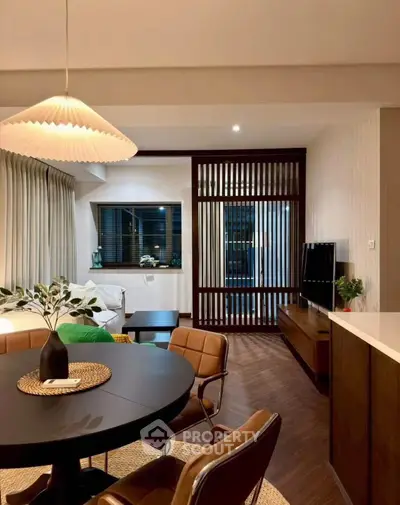 Modern open-plan living room with stylish dining area and cozy seating.