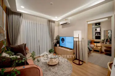 Modern living room with stylish decor and cozy ambiance, featuring a TV and elegant lighting.