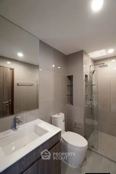 Modern bathroom with sleek fixtures and glass shower enclosure