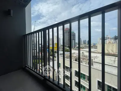 Spacious balcony with city skyline view, perfect for relaxation and enjoying urban living.