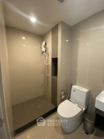 Modern bathroom with sleek shower and toilet design