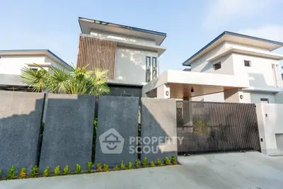 Modern architectural home exterior with sleek design and lush greenery