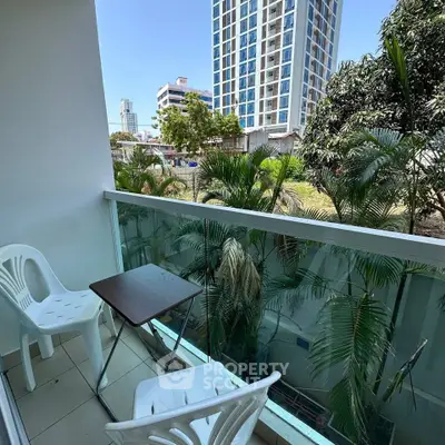 Charming balcony with lush greenery and city view, perfect for relaxation and enjoying the outdoors.