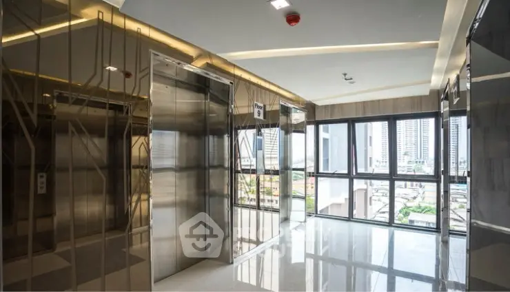 Modern building elevator lobby with sleek design and city view.