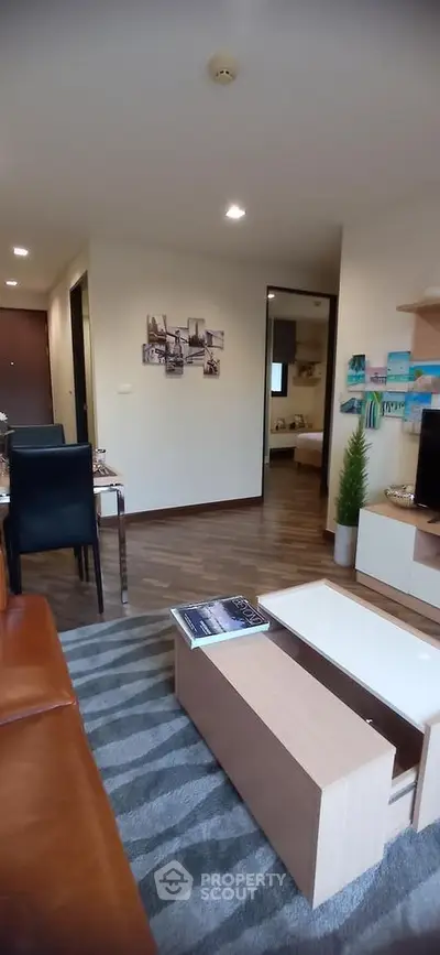 Modern living room with stylish decor and cozy ambiance in a contemporary apartment.
