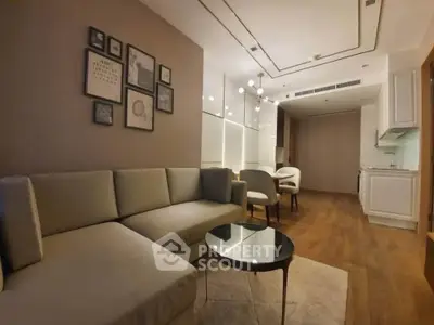 Modern living room with elegant decor and open kitchen layout, featuring cozy seating and stylish lighting.