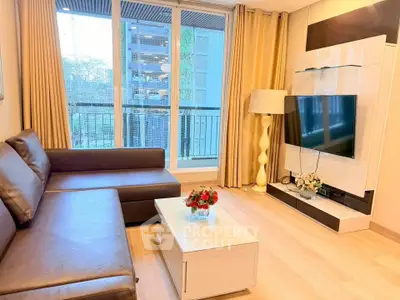 Modern living room with sleek furniture and large window offering natural light and city view.