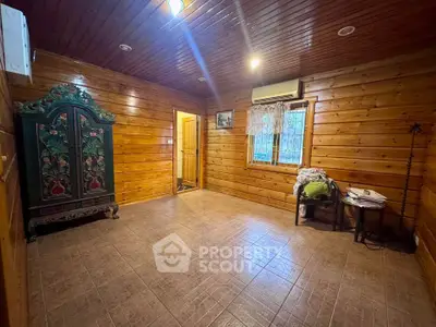 Charming rustic room with wooden walls and vintage decor, perfect for cozy living.