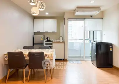 Modern dining area with kitchen and balcony access in a stylish apartment.