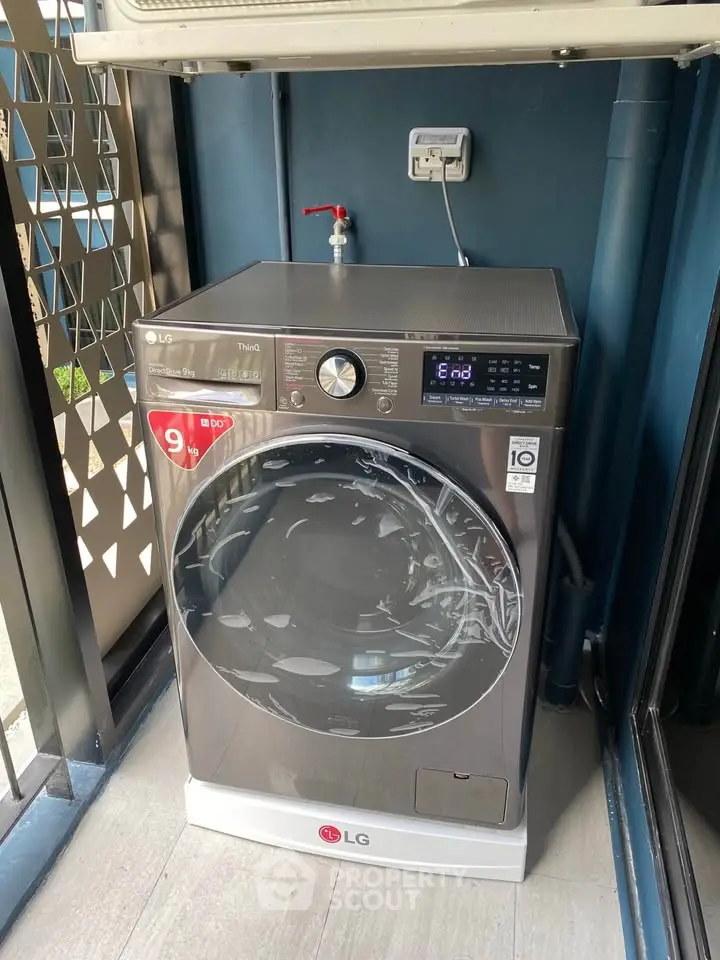 Modern LG washing machine in a sleek laundry area with contemporary design.