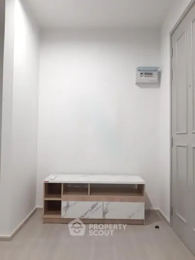 Minimalist interior with modern cabinet and neutral tones, perfect for contemporary living spaces.
