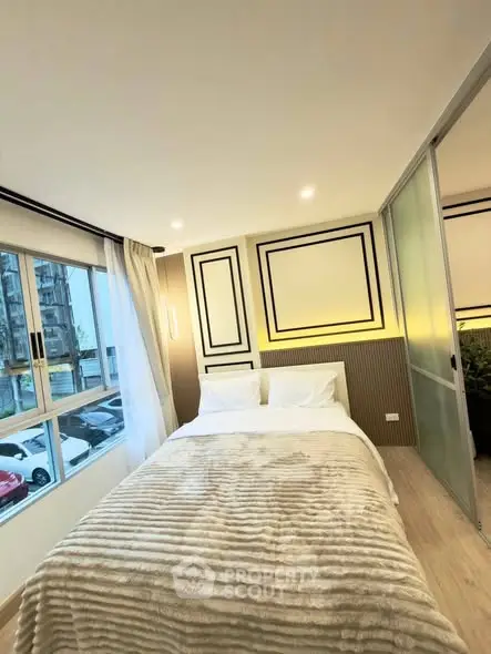 Modern bedroom with stylish decor and large window view