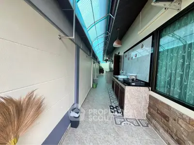 Charming outdoor corridor with modern kitchen setup and decorative flooring