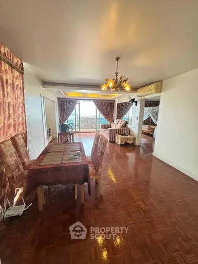 Spacious living room with elegant dining area and cozy bedroom, featuring large windows and stylish decor.