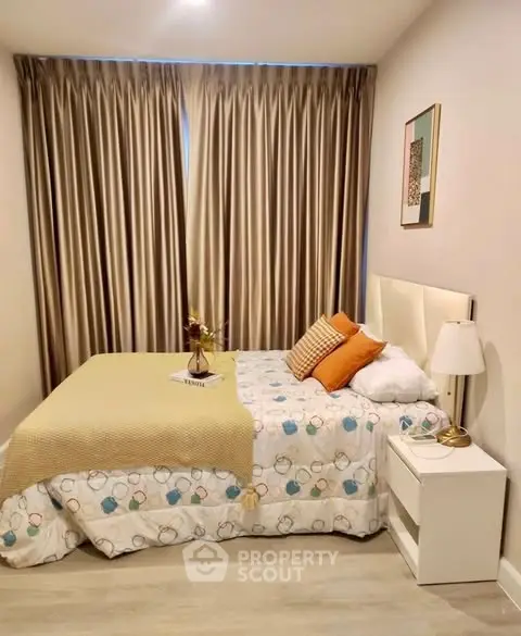 Cozy bedroom with elegant decor and soft lighting, featuring a comfortable bed and stylish curtains.
