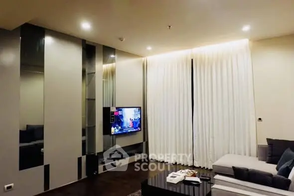 Modern living room with sleek design and cozy ambiance, featuring a wall-mounted TV and elegant curtains.