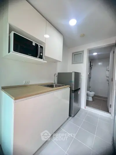 Modern compact kitchen with sleek cabinets and stainless steel appliances