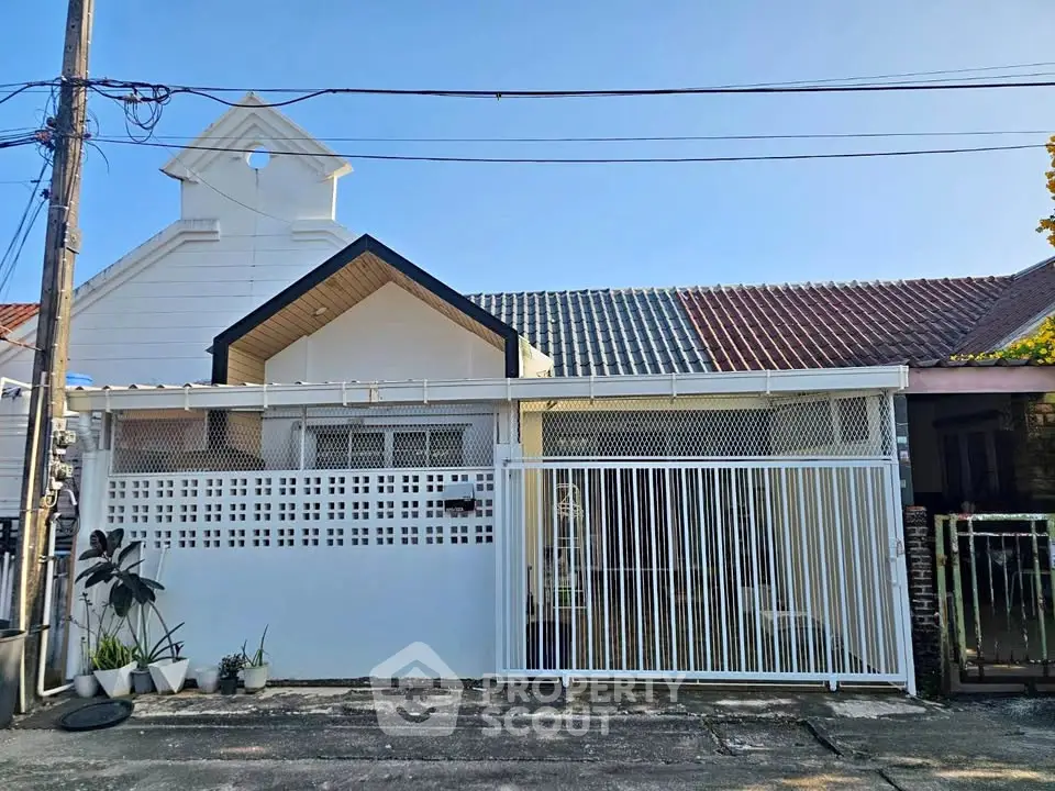 Charming single-story house with gated entrance and modern facade in a quiet neighborhood.