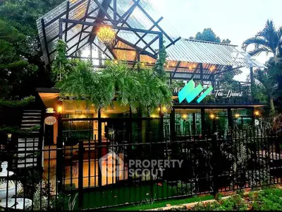 Charming glass house with lush greenery and modern design