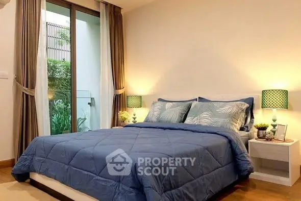 Cozy bedroom with modern decor and garden view, featuring a comfortable bed and stylish lighting.