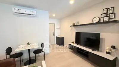 Modern living room with sleek furniture and wall-mounted TV in a stylish apartment.