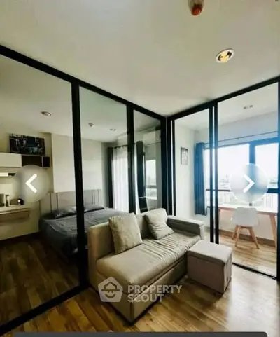 Modern living room with glass partition and cozy furniture in a stylish apartment.