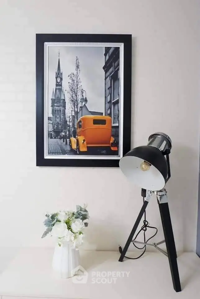 Stylish interior decor with vintage car artwork and modern lamp