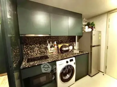 Modern compact kitchen with washing machine and sleek cabinetry