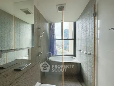 Modern bathroom with city view, featuring a sleek bathtub and contemporary fixtures.