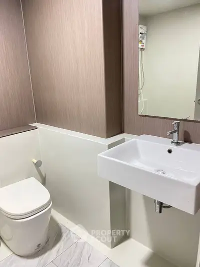 Modern bathroom with sleek sink and toilet in minimalist design