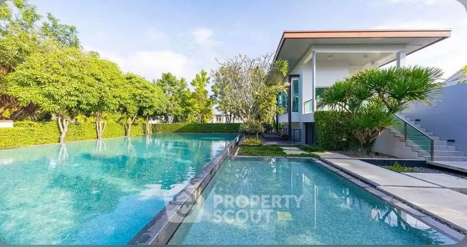 Luxurious modern villa with stunning pool and lush greenery