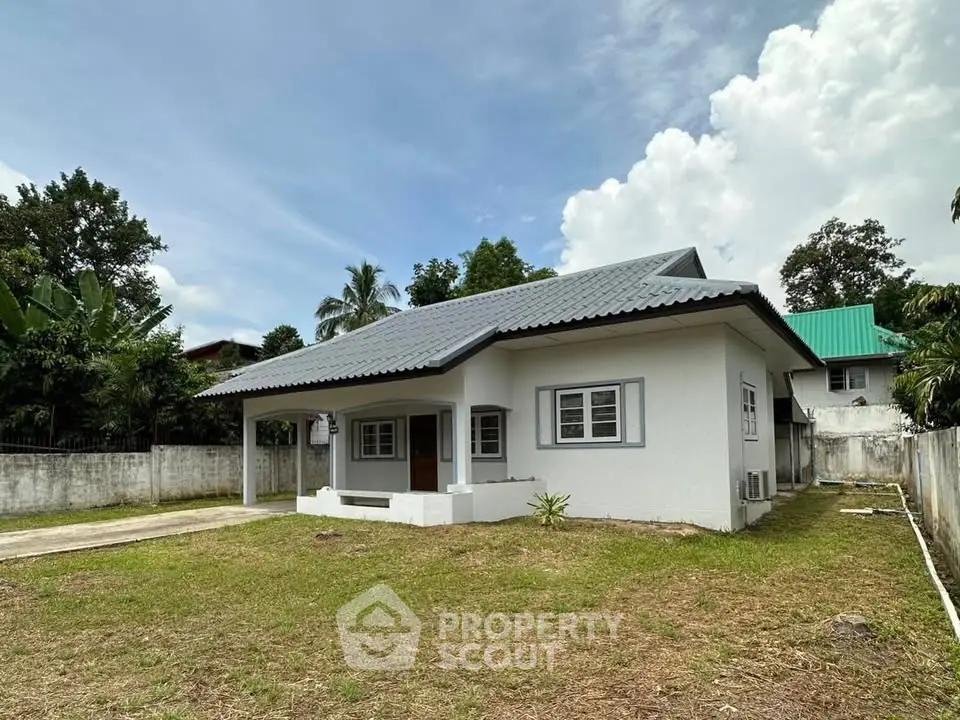 Charming single-story home with spacious yard and modern roof design, perfect for family living.