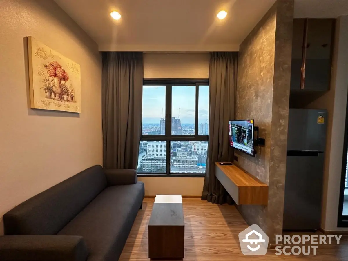 Modern living room with city view, sleek furniture, and wall-mounted TV in stylish apartment.