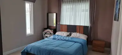 Cozy bedroom with modern decor and natural light, featuring a comfortable bed and stylish furniture.