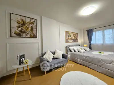 Modern bedroom with cozy seating area and stylish decor