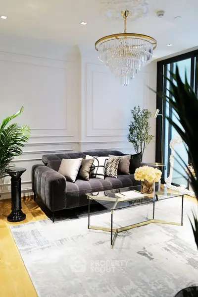 Luxurious living room with elegant chandelier and plush velvet sofa