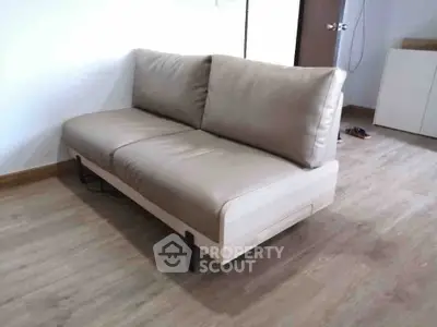 Modern minimalist sofa in a stylish living room with wooden flooring.