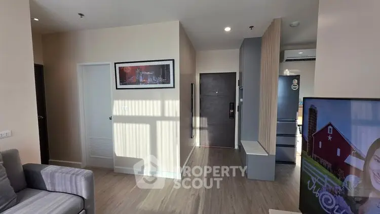 Modern apartment interior with stylish decor and open layout, featuring a cozy living area and sleek kitchen.