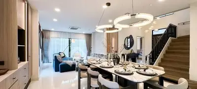 Luxurious open-plan living and dining area with modern decor and elegant lighting.