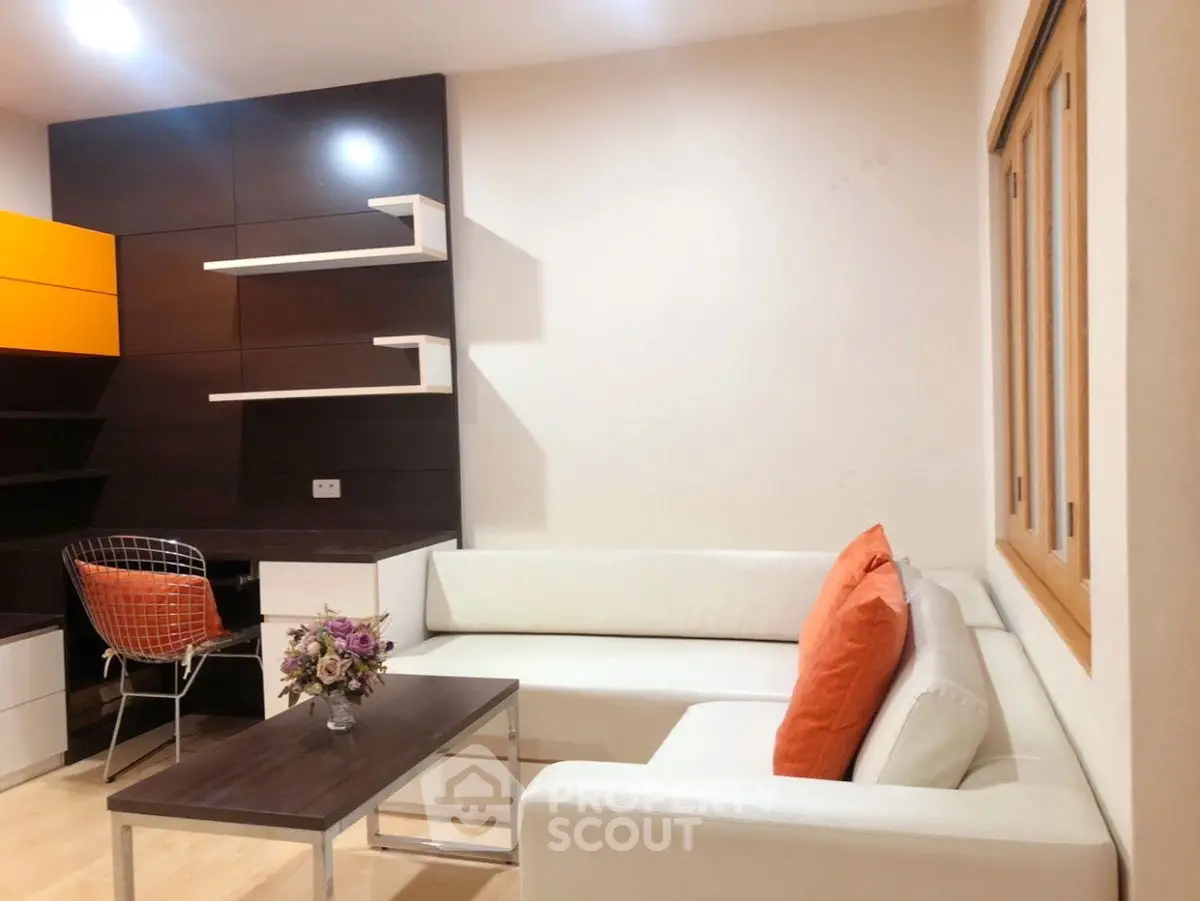 Modern living room with white sectional sofa and stylish decor