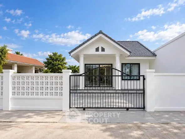 Charming single-story home with modern design and gated entrance, perfect for family living.
