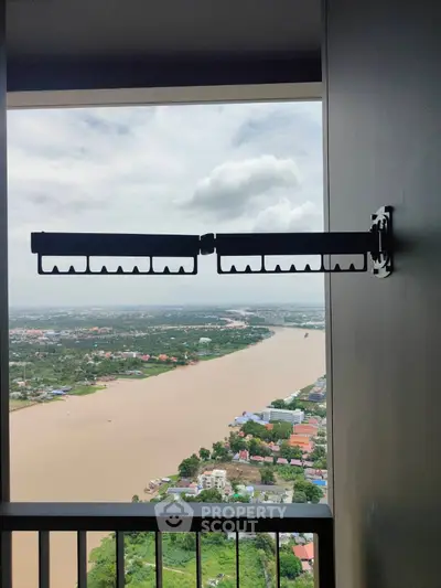 Stunning river view from high-rise balcony with clothes drying rack.