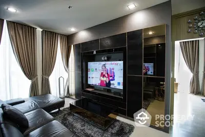 Luxurious modern living room with sleek leather sofa and large TV entertainment center.