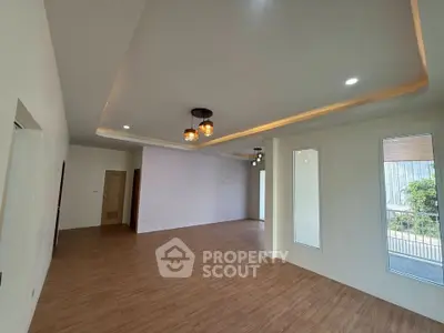 Spacious modern living room with elegant lighting and wooden flooring
