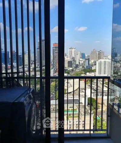 Stunning city view from high-rise balcony with laundry area, perfect urban living.
