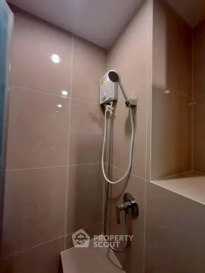 Modern bathroom with sleek shower design and built-in seating area.