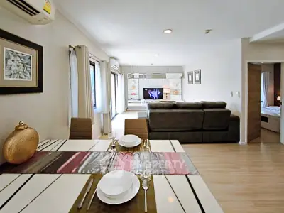 Spacious open-plan living and dining area with modern decor and ample natural light.