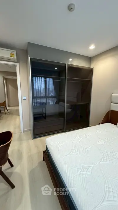 Modern bedroom with sleek wardrobe and comfortable bed in stylish apartment