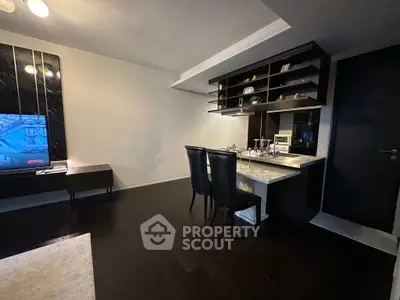 Modern living room with sleek dark flooring and stylish dining area