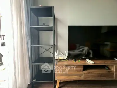Modern living room with sleek TV stand and open shelving unit.